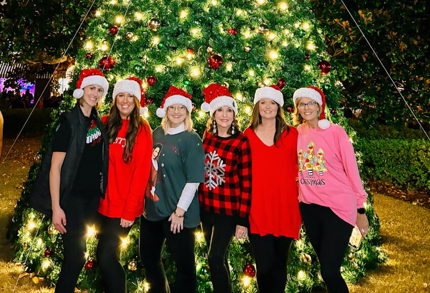 Christmas Committee members Jessica Pickering, Briana Petty, Amanda Richardson, Jenny Lynn Wilkerson, Jonni Myers, and Lisa Nowell pose in front of the majestic 26-foot Christmas tree after the Hometown Christmas tree lighting event held on Friday, Dec. 1. on the Square.